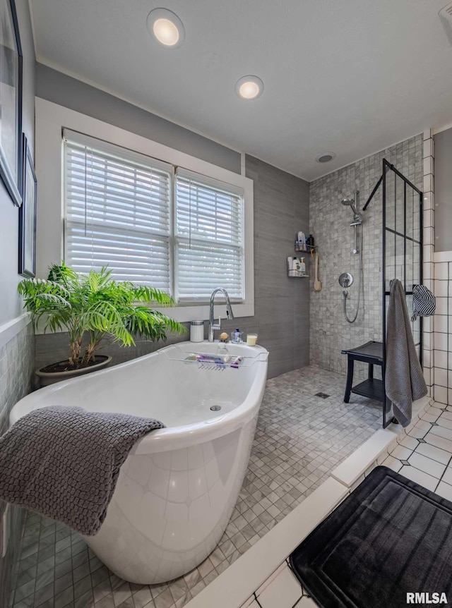 3160 Sycamore Rd, Carterville, IL 62918 - bathroom featuring tile walls, a walk in shower, a soaking tub, tile patterned floors, and recessed lighting