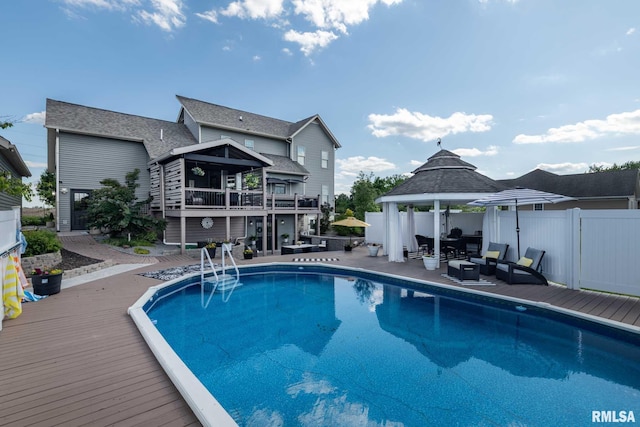 3160 Sycamore Rd, Carterville, IL 62918 - view of pool with a gazebo, an outdoor living space, a deck, a fenced backyard, and a patio