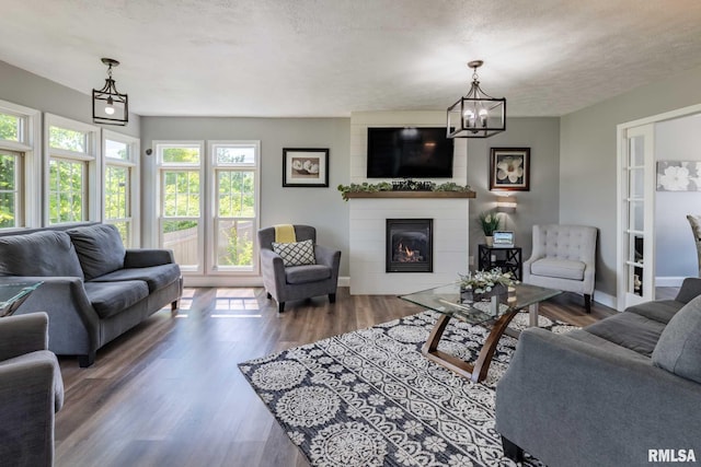 3160 Sycamore Rd, Carterville, IL 62918 - living room with a fireplace, wood finished floors, a textured ceiling, a chandelier, and baseboards