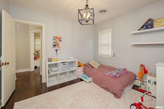 807 Spalding Blvd, Davenport, IA 52804 - bedroom with a chandelier, a baseboard heating unit, and wood finished floors