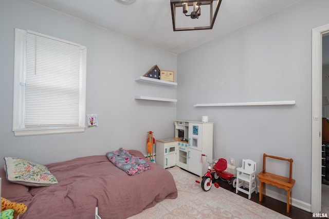 807 Spalding Blvd, Davenport, IA 52804 - bedroom with a chandelier and wood finished floors