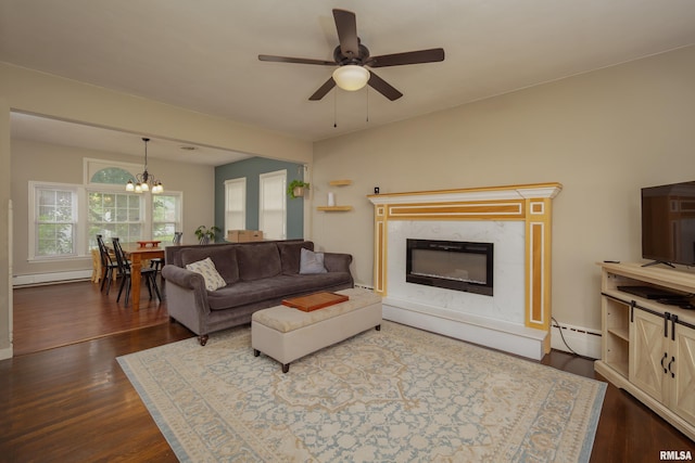 807 Spalding Blvd, Davenport, IA 52804 - living area featuring a baseboard heating unit, a baseboard radiator, a chandelier, dark wood-style flooring, and a ceiling fan