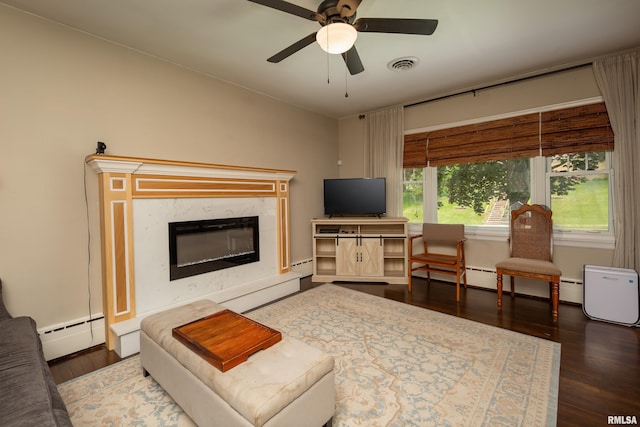 807 Spalding Blvd, Davenport, IA 52804 - living area featuring baseboard heating, a premium fireplace, ceiling fan, and wood finished floors