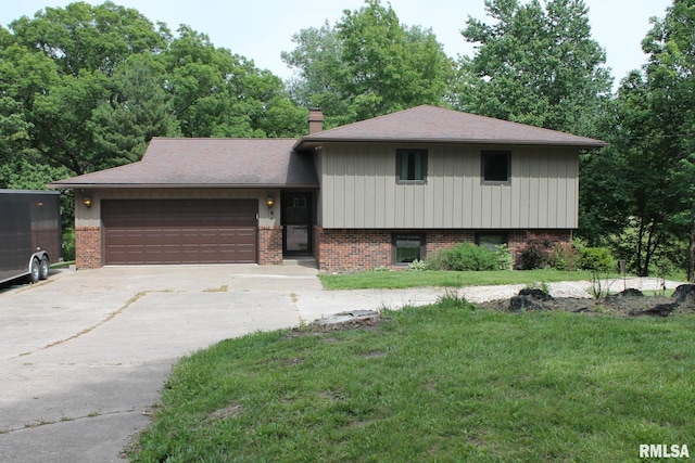 24176 Stagecoach Rd, Geneseo, IL 61254 - tri-level home with an attached garage, driveway, brick siding, a front lawn, and a chimney