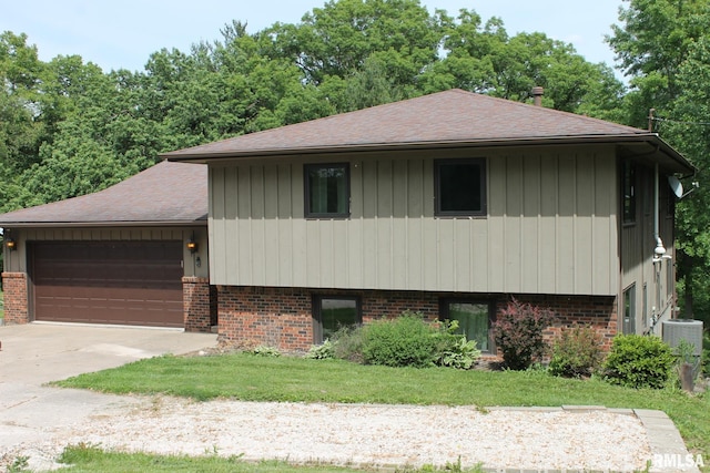 24176 Stagecoach Rd, Geneseo, IL 61254 - view of front facade with brick siding, concrete driveway, a garage, a shingled roof, and cooling unit