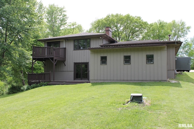 24176 Stagecoach Rd, Geneseo, IL 61254 - back of property featuring a chimney, a lawn, board and batten siding, and a deck