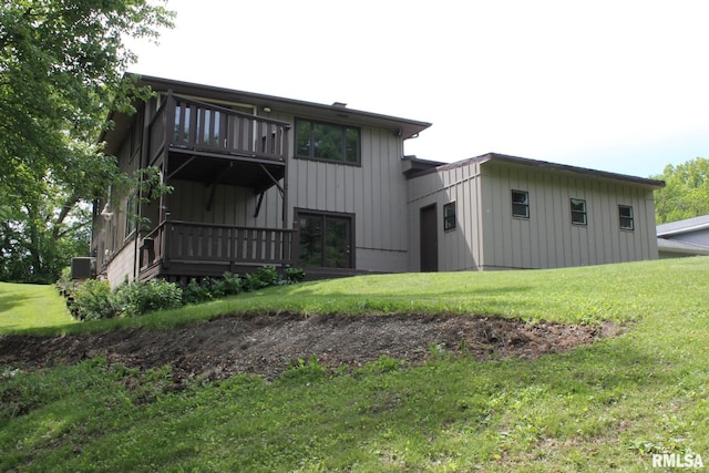 24176 Stagecoach Rd, Geneseo, IL 61254 - rear view of property with central AC, board and batten siding, and a yard