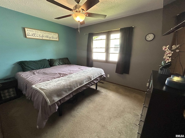 709S 4th St S, Maquoketa, IA 52060 - bedroom featuring a textured ceiling, carpet flooring, and a ceiling fan