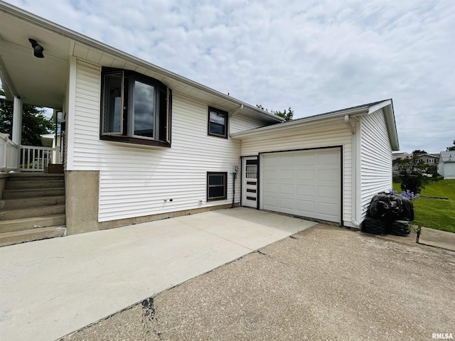709S 4th St S, Maquoketa, IA 52060 - view of side of property with concrete driveway and an attached garage