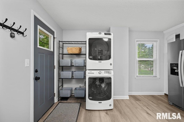 1156 23rd St, Moline, IL 61265 - laundry room with stacked washer and clothes dryer, wood finished floors, and a textured ceiling