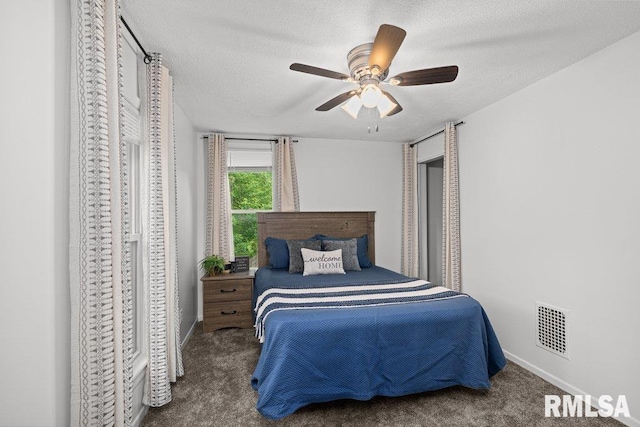 1156 23rd St, Moline, IL 61265 - carpeted bedroom featuring a textured ceiling and ceiling fan