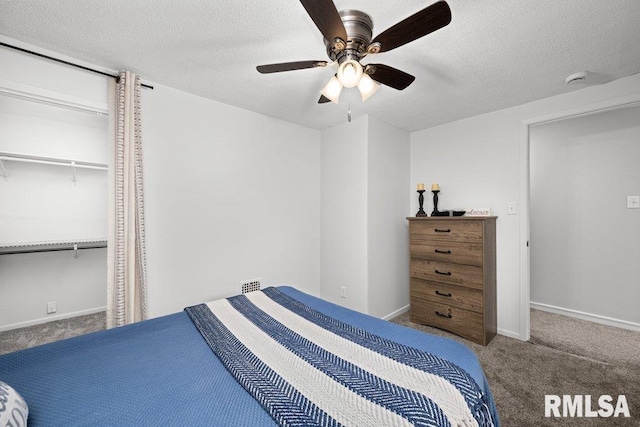 1156 23rd St, Moline, IL 61265 - carpeted bedroom featuring a textured ceiling and a ceiling fan
