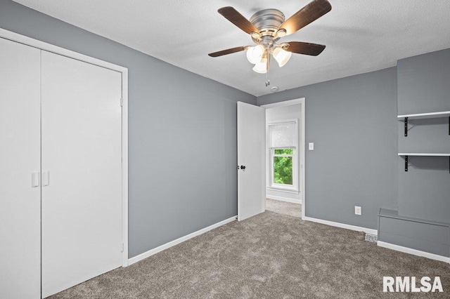 1156 23rd St, Moline, IL 61265 - unfurnished bedroom with carpet, ceiling fan, and a textured ceiling