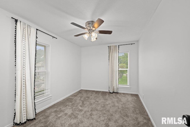 1156 23rd St, Moline, IL 61265 - empty room featuring healthy amount of natural light, a ceiling fan, carpet floors, and a textured ceiling