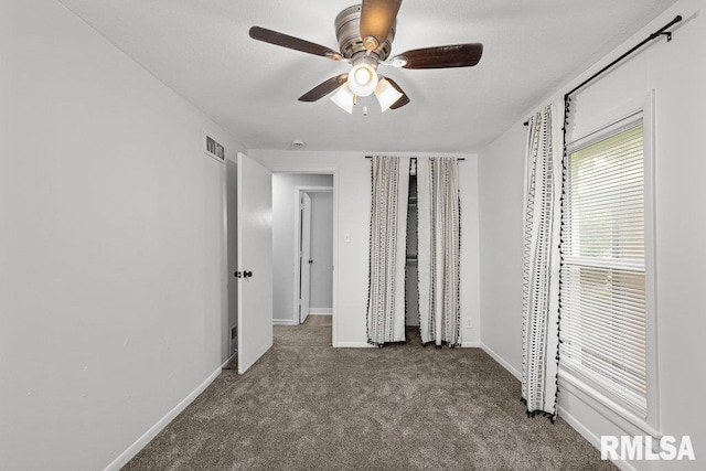 1156 23rd St, Moline, IL 61265 - unfurnished bedroom with carpet flooring and a ceiling fan