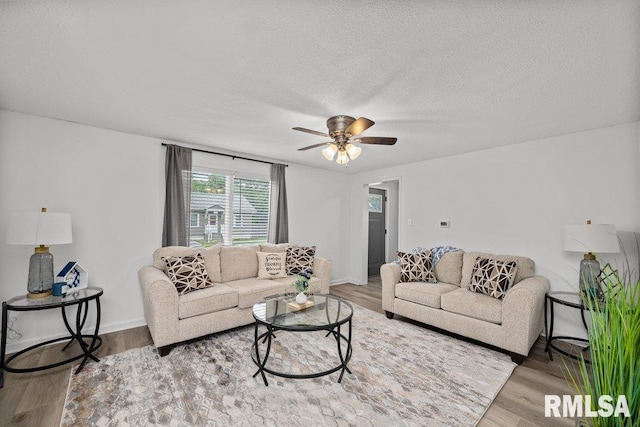 1156 23rd St, Moline, IL 61265 - living room featuring ceiling fan, wood finished floors, and a textured ceiling