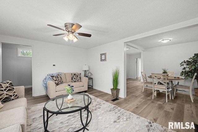 1156 23rd St, Moline, IL 61265 - living area featuring ceiling fan, wood finished floors, and a textured ceiling