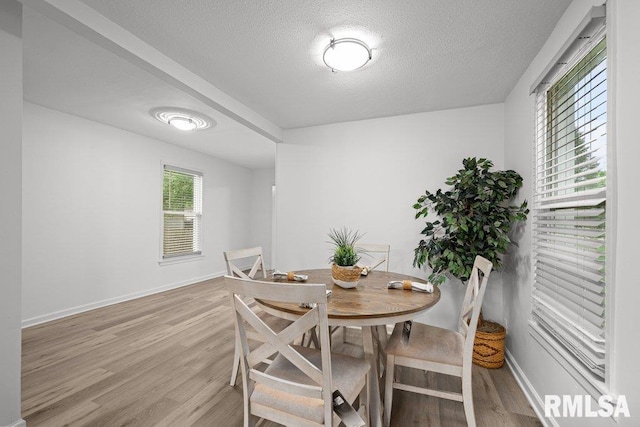 1156 23rd St, Moline, IL 61265 - dining space featuring a textured ceiling and light wood-style floors