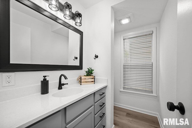 1156 23rd St, Moline, IL 61265 - bathroom featuring vanity and wood finished floors