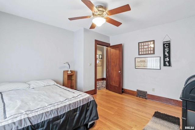 924 Brown St, Bettendorf, IA 52722 - bedroom featuring light wood-style floors, baseboards, and ceiling fan