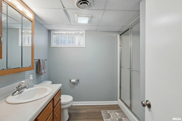 924 Brown St, Bettendorf, IA 52722 - full bathroom with vanity, wood finished floors, a stall shower, toilet, and baseboards