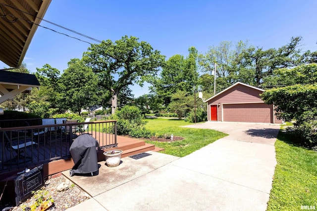 924 Brown St, Bettendorf, IA 52722 - view of grassy yard featuring a detached garage, a deck, and an outbuilding