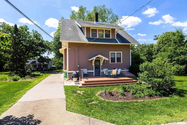 924 Brown St, Bettendorf, IA 52722 - back of property with a deck, a yard, a chimney, and a shingled roof