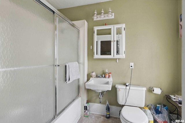 1931 E 11th St, Davenport, IA 52803 - bathroom with toilet, enclosed tub / shower combo, tile patterned flooring, and a sink