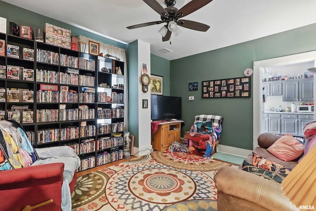 1931 E 11th St, Davenport, IA 52803 - living room featuring ceiling fan and baseboards