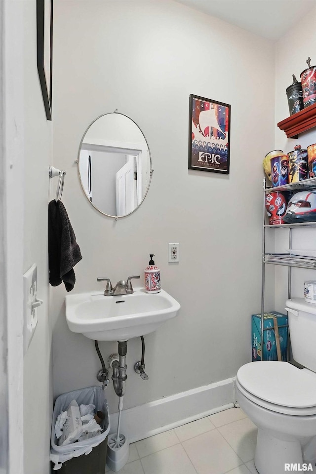 1931 E 11th St, Davenport, IA 52803 - bathroom featuring toilet, tile patterned floors, and baseboards