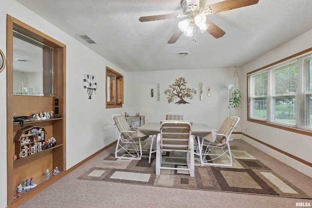 1119 14th St, Bettendorf, IA 52722 - carpeted dining space featuring baseboards, ceiling fan, and a textured ceiling