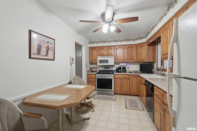 1119 14th St, Bettendorf, IA 52722 - kitchen featuring white appliances, light floors, a sink, a ceiling fan, and light countertops