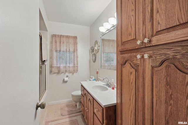 1119 14th St, Bettendorf, IA 52722 - full bath with vanity, an enclosed shower, toilet, and baseboards