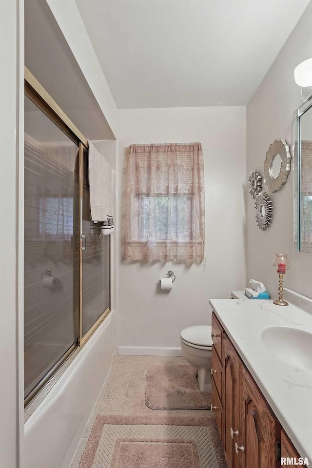 1119 14th St, Bettendorf, IA 52722 - bathroom featuring vanity, shower / bath combination with glass door, toilet, tile patterned floors, and baseboards