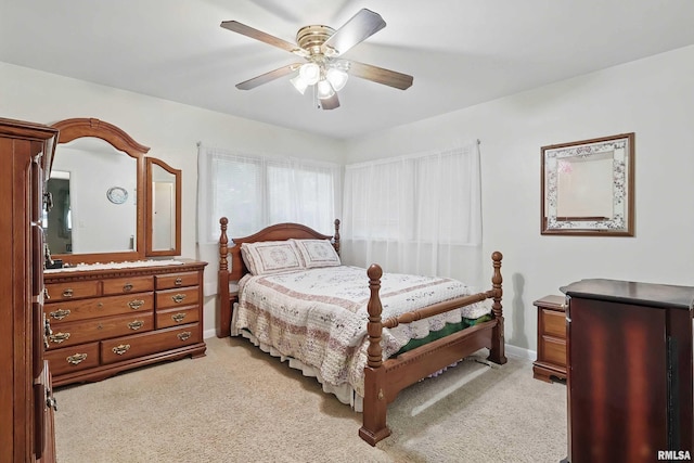 1119 14th St, Bettendorf, IA 52722 - bedroom with light colored carpet, a ceiling fan, and baseboards