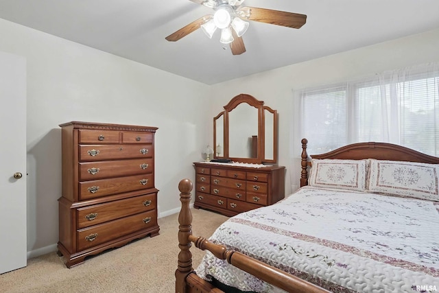 1119 14th St, Bettendorf, IA 52722 - bedroom featuring light carpet, a ceiling fan, and baseboards