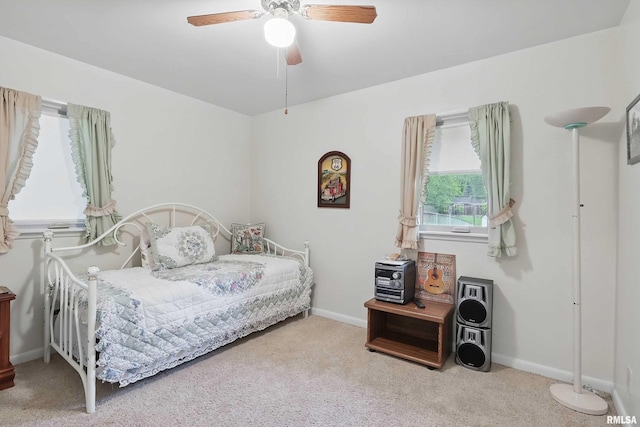 1119 14th St, Bettendorf, IA 52722 - carpeted bedroom featuring baseboards and a ceiling fan
