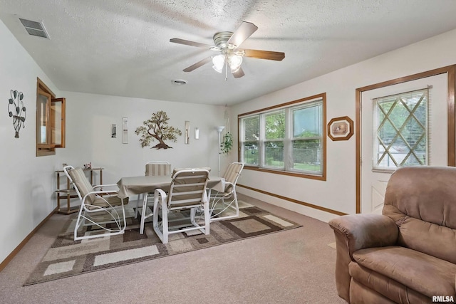 1119 14th St, Bettendorf, IA 52722 - carpeted dining area featuring baseboards, ceiling fan, and a textured ceiling