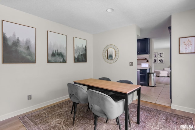 28013 230th St, Le Claire, IA 52753 - dining room featuring light wood-style flooring and baseboards
