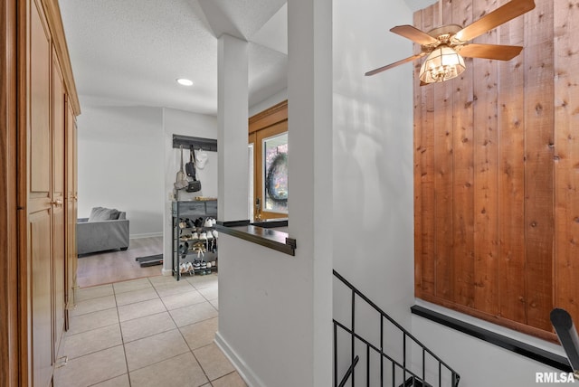 28013 230th St, Le Claire, IA 52753 - hall featuring light tile patterned floors, baseboards, an upstairs landing, and recessed lighting