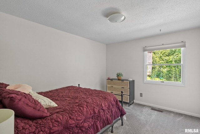 28013 230th St, Le Claire, IA 52753 - bedroom with baseboards, light colored carpet, and a textured ceiling