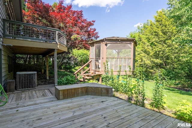 28013 230th St, Le Claire, IA 52753 - deck with central air condition unit and a sunroom