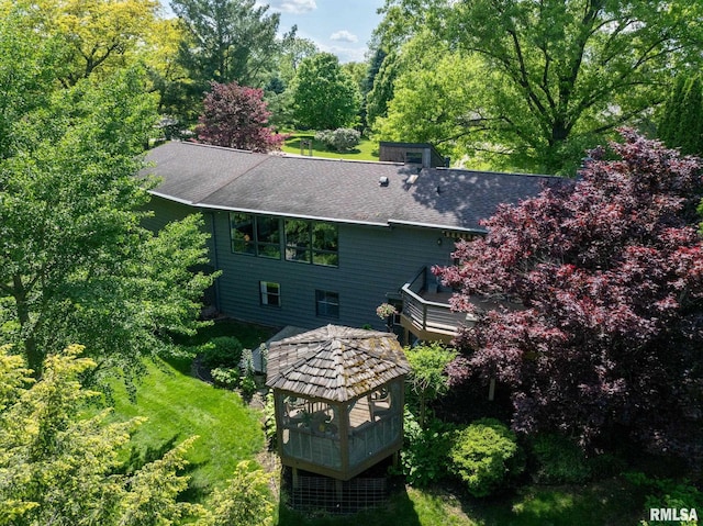 28013 230th St, Le Claire, IA 52753 - rear view of property featuring roof with shingles and a deck
