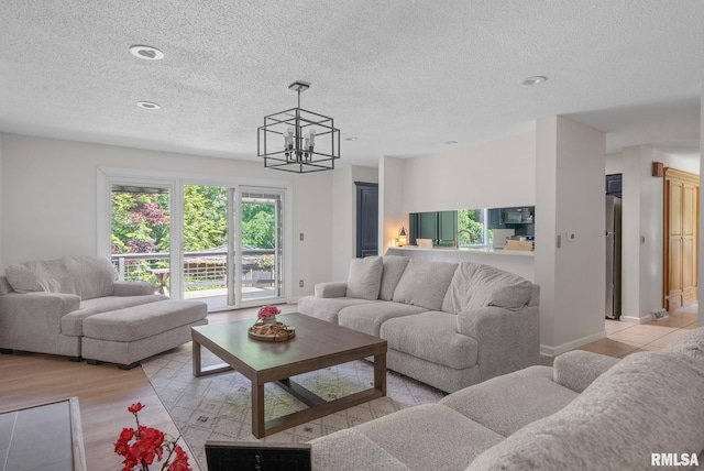 28013 230th St, Le Claire, IA 52753 - living area featuring a chandelier, a textured ceiling, and recessed lighting