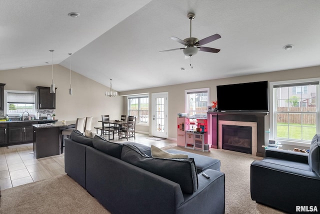 1625 W 71st St, Davenport, IA 52806 - living area with lofted ceiling, a fireplace, light carpet, and ceiling fan