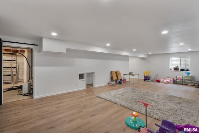1625 W 71st St, Davenport, IA 52806 - recreation room featuring recessed lighting, wood finished floors, and baseboards