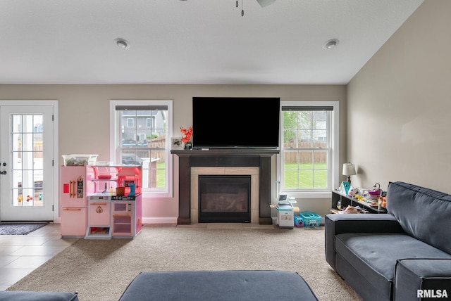 1625 W 71st St, Davenport, IA 52806 - living room featuring a glass covered fireplace, a ceiling fan, baseboards, and carpet flooring