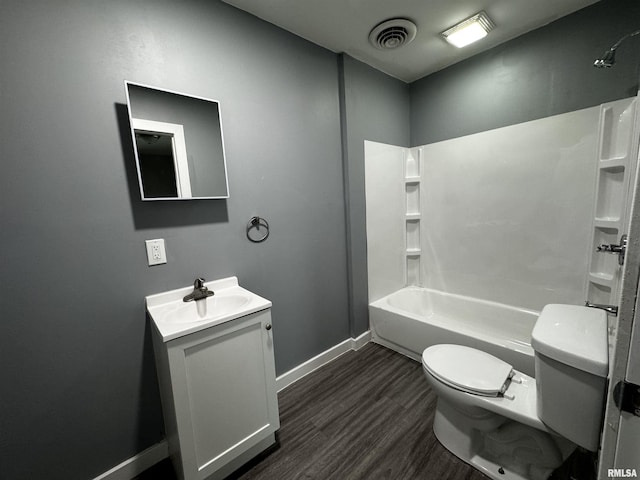 2107 N Marquette St, Davenport, IA 52804 - full bathroom with toilet, vanity, wood finished floors, baseboards, and bathtub / shower combination