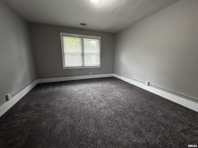 2107 N Marquette St, Davenport, IA 52804 - spare room with dark carpet and baseboards
