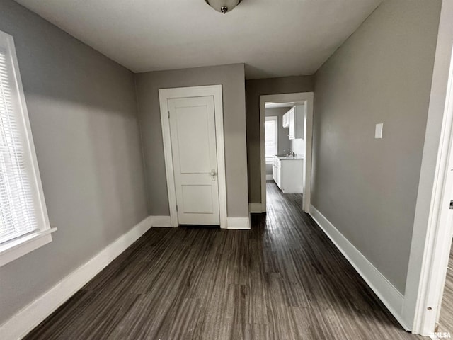 2107 N Marquette St, Davenport, IA 52804 - unfurnished bedroom featuring baseboards and dark wood-style flooring
